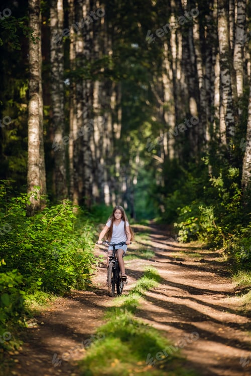Preview: Children girl riding bicycle outdoor in forest smiling
