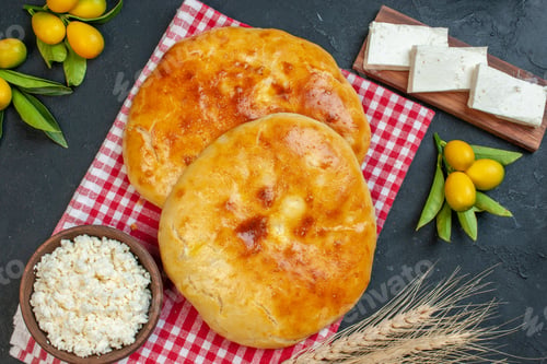 Preview: Above view of delicous fresh baked pastries on red stripped towel and spike cheese kumquats salad