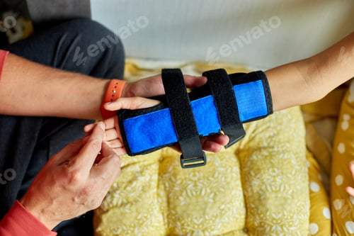 Preview: Physical Therapist Fitting a Support Brace on a Young Girls Arm