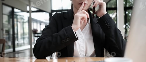 Preview: Closeup businesswoman talking Secrets on the phone.