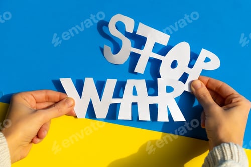 Preview: Stop war, conflict between Ukraine and Russia. Hands of a woman holding an anti war symbol