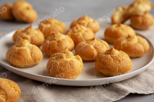 Preview: Homemade Mini Cream Puffs on a Plate, low angle view.