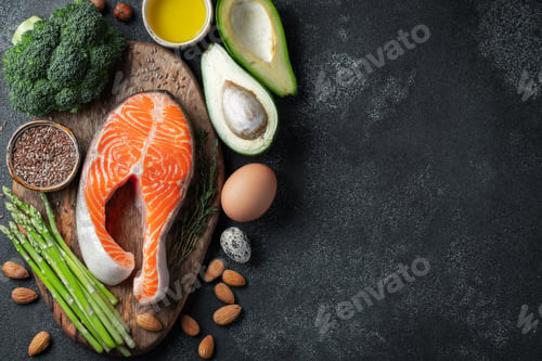 Preview: A set of healthy food for keto diet on a dark background. Fresh raw salmon steak with flax seeds