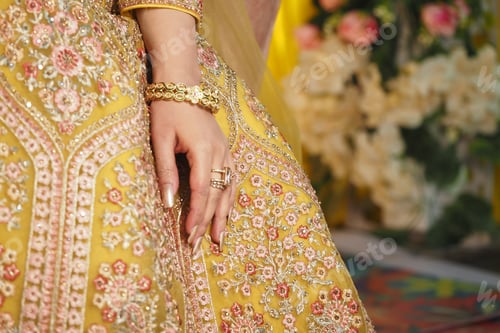 Preview: Elegant bridal attire adorned with intricate embroidery and details