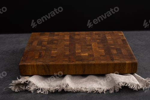 Visualização: Tábua de cortar em uma mesa de pedra cinza. Isolado em um fundo preto. Antecedentes culinários. Vazio