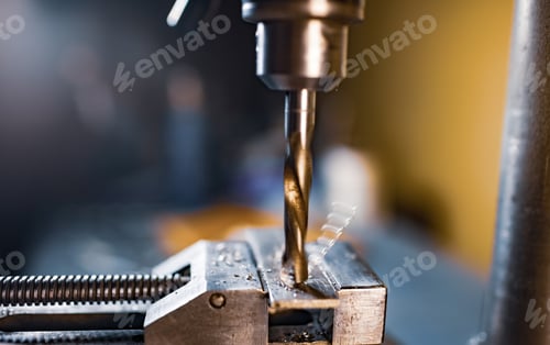 Preview: Drilling process with shavings close-up at the workplace in workshop