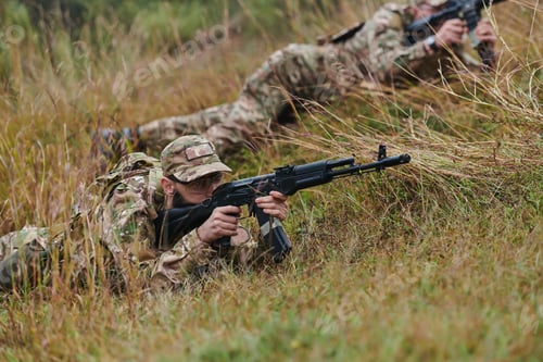 Preview: Elite soldiers stealthily maneuver through the dense forest, camouflaged in specialized gear, as