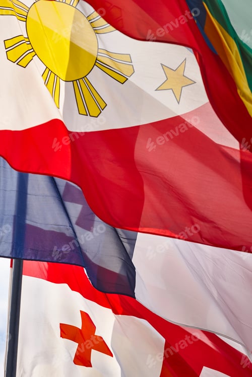 Preview: Colorful Flags Waving Against a Light Sky