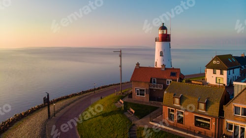 Preview: Urk Flevoland Netherlands sunset at the lighthouse and harbor of Urk Holland. Fishing village Urk