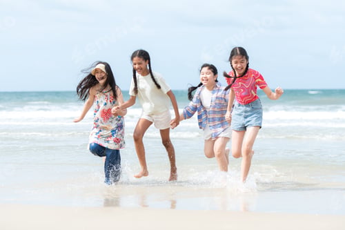 Preview: Happy children playing together in the sea, enjoying a fun summer day at the beach