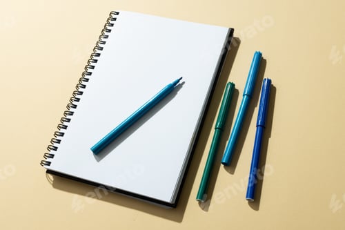 Preview: Close up of notebook and four markers with copy space on yellow background