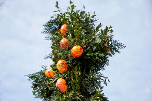 Preview: Selective focus of colorful Easter eggs on a tree in a park