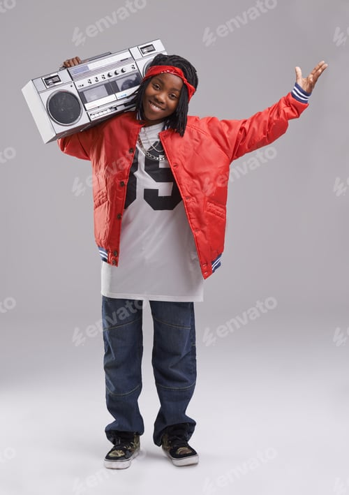Preview: What do you think. Studio shot of a young boy dressed in hip hop attire.