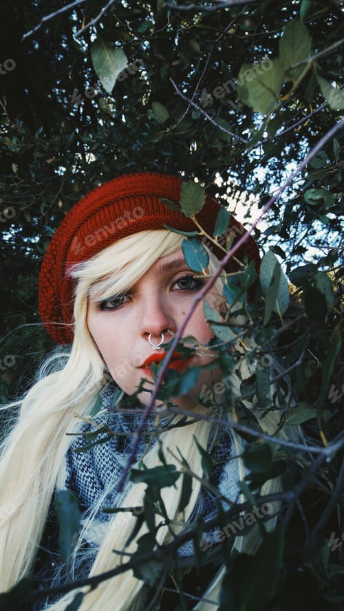 Preview: Young blonde woman alone in a forest in autumn