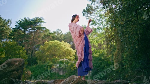 Preview: Glamorous girl standing forest lake in original clothing. Fantasy model posing