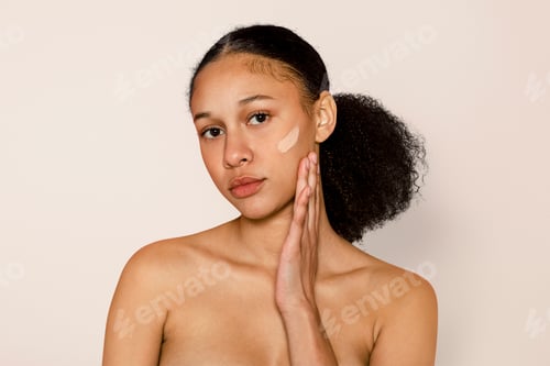 Preview: Woman applying foundation on tanned skin, makeup & cosmetics