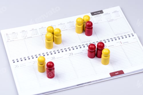 Preview: Closeup of dates in a calendar indicated by red and yellowfigures