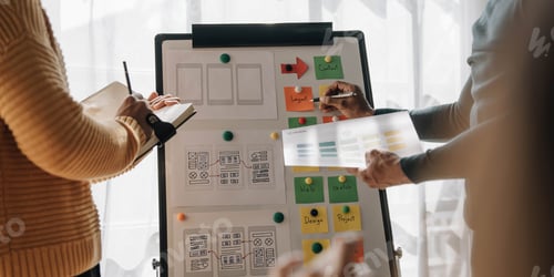 Preview: Close up ux developer and ui designer brainstorming about mobile app interface wireframe design on