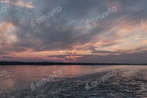 Preview: Dramatic sunset on Volga river with pink and gray clouds, Russia
