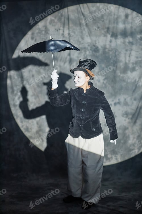 Preview: Classic Mime Acting on Stage and Holding Umbrella