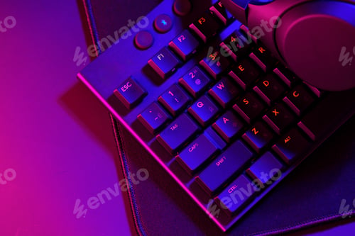 Preview: Headphones on a computer keyboard on black background