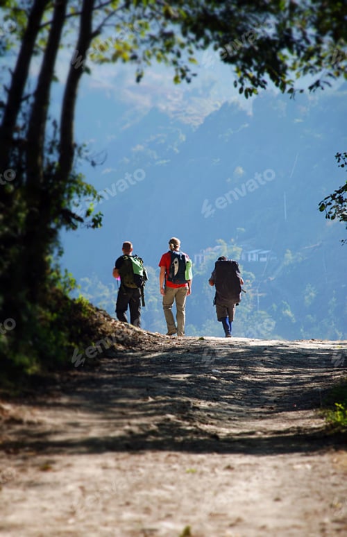 Preview: Three people hiking along a dirt track carrying backpacks on an adventure