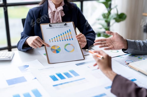 Preview: Business Meeting Discussing Financial Charts in Office Setting