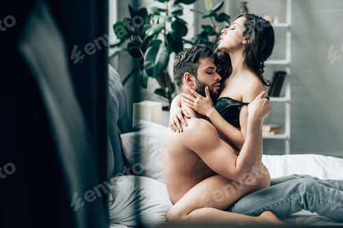 Preview: selective focus of shirtless man undressing attractive brunette girl in underwear
