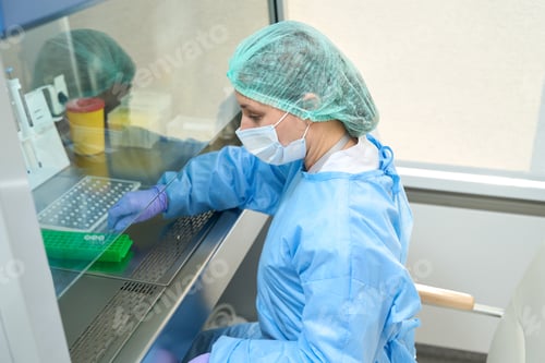 Preview: Female virologist works with virus samples in a sterile room