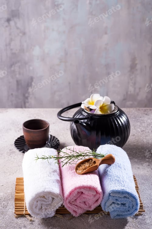 Preview: Color towels with green leaves, spoon of salt and detox tea on bamboo mat and stone table