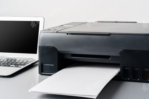 Preview: Printer and laptop on grey table in office