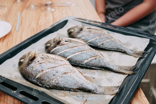 Preview: Baked Dorado fish in the oven. Cooking Dorado fish in the cooking class. Baked fish, selective focus