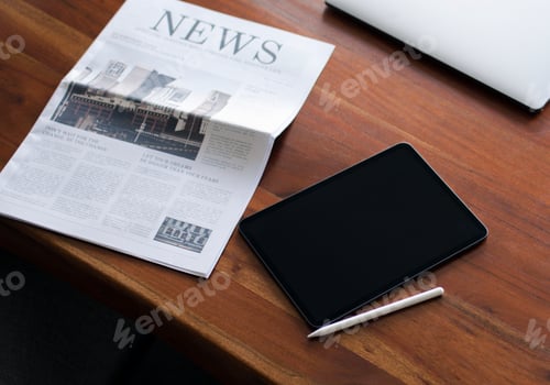 Preview: Newspaper on a table with a digital tablet