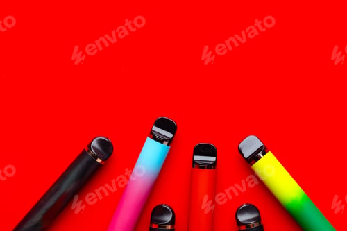 Preview: Colorful disposable electronic cigarettes on red background