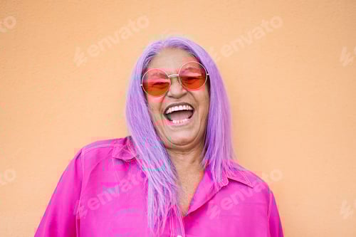 Preview: Senior Woman Laughing with Bright Pink Hair