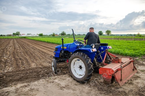 Preview: Kherson oblast, Ukraine - May 29, 2021: A farmer on a tractor clears the field.