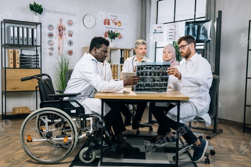 Preview: Multiracial doctors discussing x ray scan at conference room