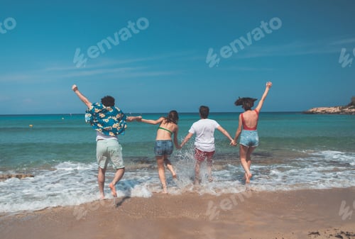 Preview: Carefree Young Men And Women Are Going Into The Water Together. They Are Holding Hands With Joy