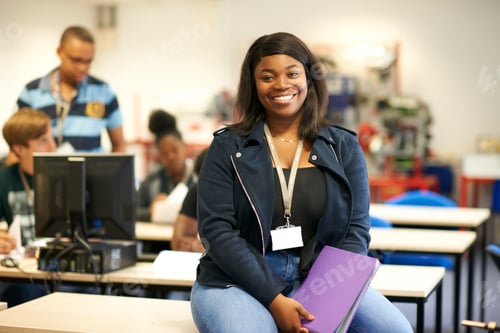 Preview: Young female higher education student in college classroom, portrait