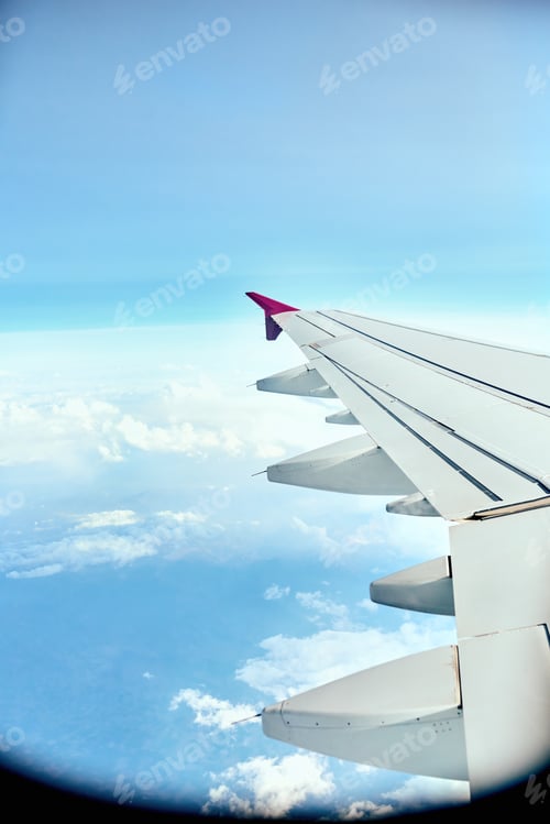 Preview: Finally in the air. Shot of an aeroplanes wing while flying.