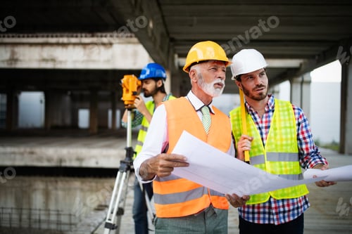 Preview: Team of architects and engineer in group on construciton site check documents and business workflow