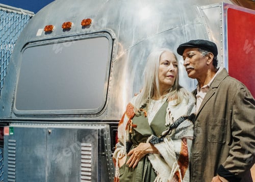 Preview: Cool senior couple standing by the food truck