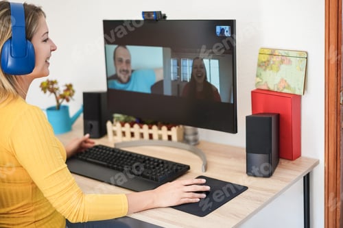 Preview: Young woman having video call party with friends using computer at home - Focus on right hand