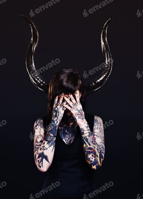 Preview: The dark side. Studio shot of a tattooed young woman.