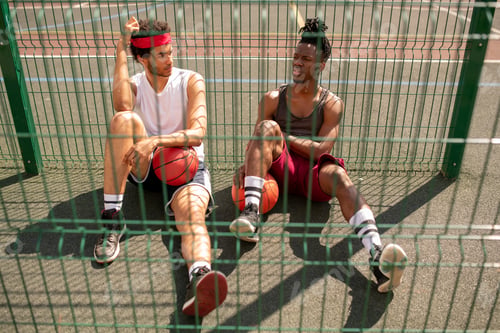 Preview: One of young intercultural basketballers telling his friend of game details