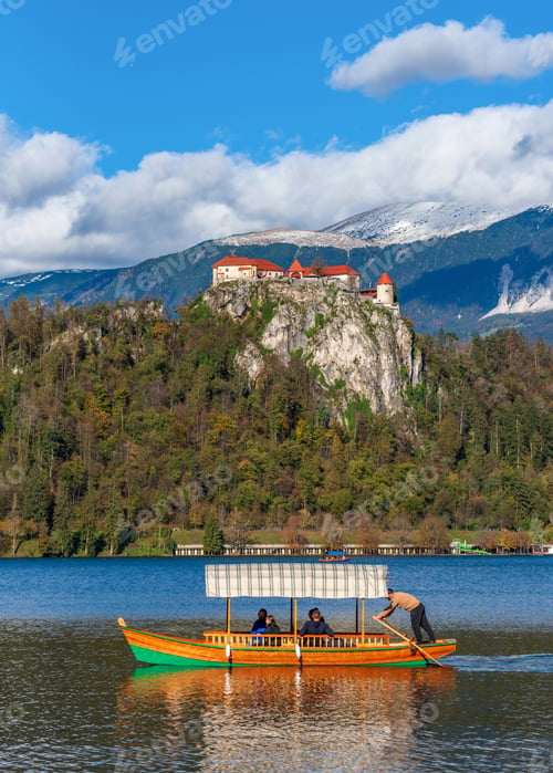 Preview: Traditional tourist boat on lake under Bled castle in Slovenia