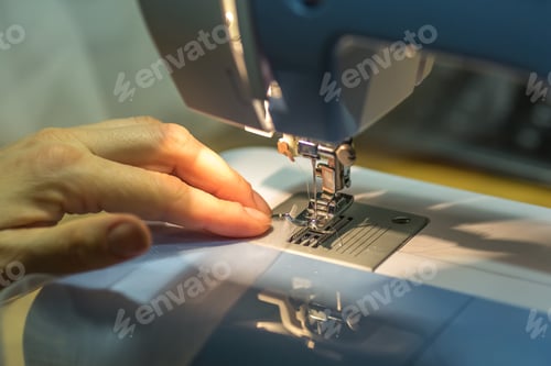 Preview: close up mechanism of sewing machine foot with needle and thread