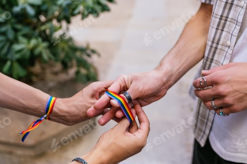 Preview: Hands Holding a Rainbow Ribbon with Pride
