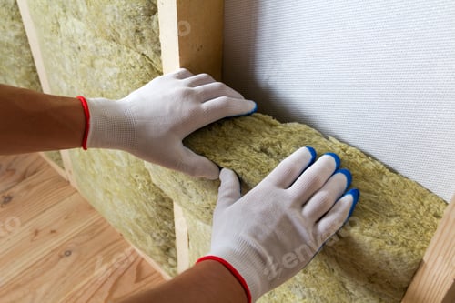 Preview: Close-up of worker hands in white gloves insulating rock wool insulation staff