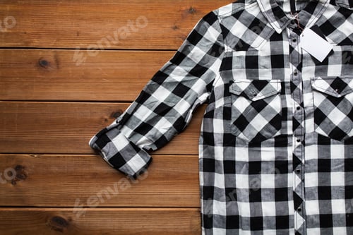 Preview: close up of checkered shirt on wooden background